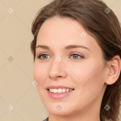 Joyful white young-adult female with medium  brown hair and green eyes