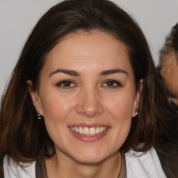 Joyful white adult female with medium  brown hair and brown eyes