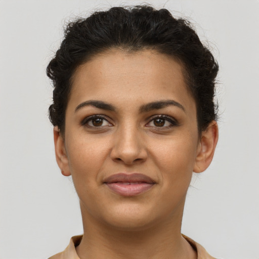 Joyful latino young-adult female with short  brown hair and brown eyes