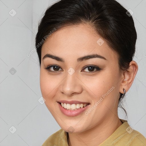 Joyful latino young-adult female with medium  brown hair and brown eyes