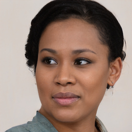 Joyful black young-adult female with medium  black hair and brown eyes