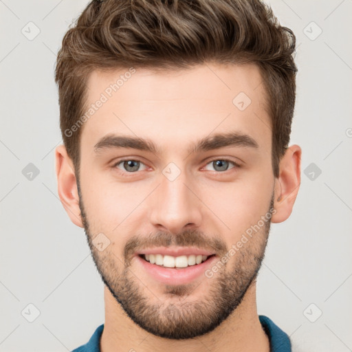 Joyful white young-adult male with short  brown hair and grey eyes