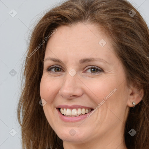 Joyful white adult female with long  brown hair and brown eyes