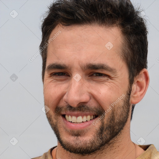 Joyful white adult male with short  brown hair and brown eyes