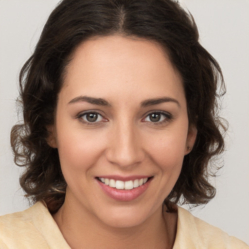 Joyful white young-adult female with medium  brown hair and brown eyes