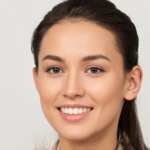 Joyful white young-adult female with long  brown hair and brown eyes