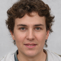 Joyful white young-adult male with medium  brown hair and brown eyes