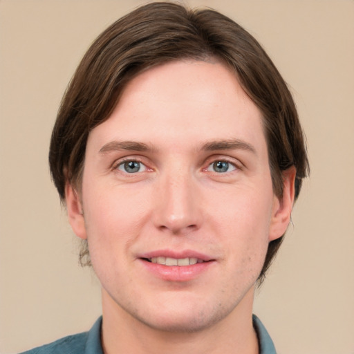 Joyful white young-adult male with medium  brown hair and grey eyes