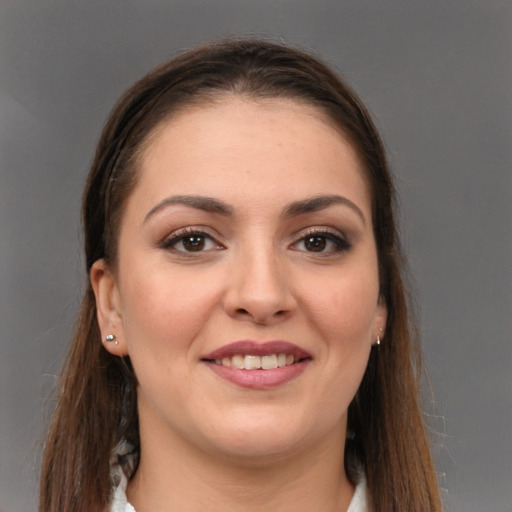 Joyful white young-adult female with long  brown hair and brown eyes