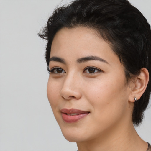 Joyful white young-adult female with medium  black hair and brown eyes