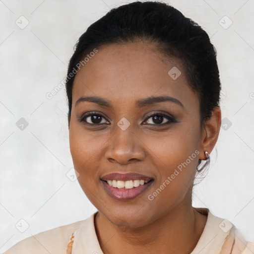 Joyful black young-adult female with short  black hair and brown eyes