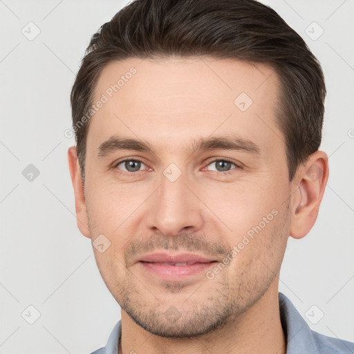 Joyful white young-adult male with short  brown hair and brown eyes