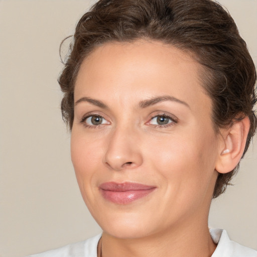 Joyful white adult female with medium  brown hair and brown eyes