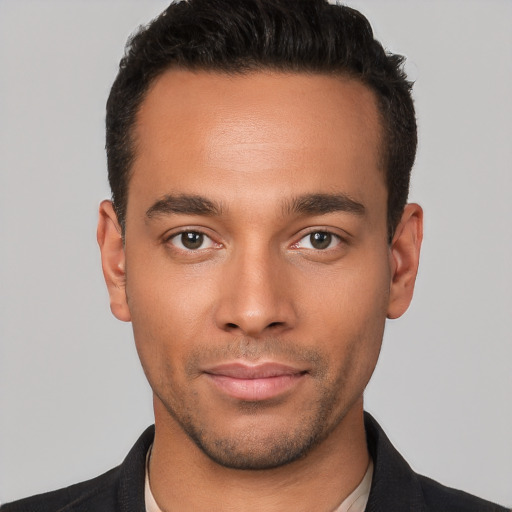 Joyful white young-adult male with short  black hair and brown eyes