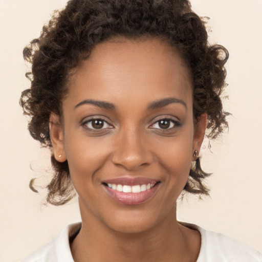 Joyful black young-adult female with short  brown hair and brown eyes