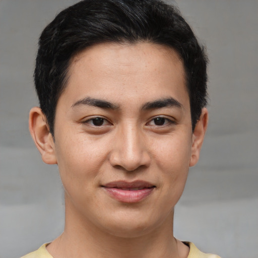 Joyful asian young-adult male with short  brown hair and brown eyes