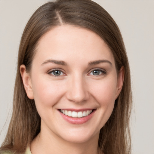 Joyful white young-adult female with long  brown hair and grey eyes