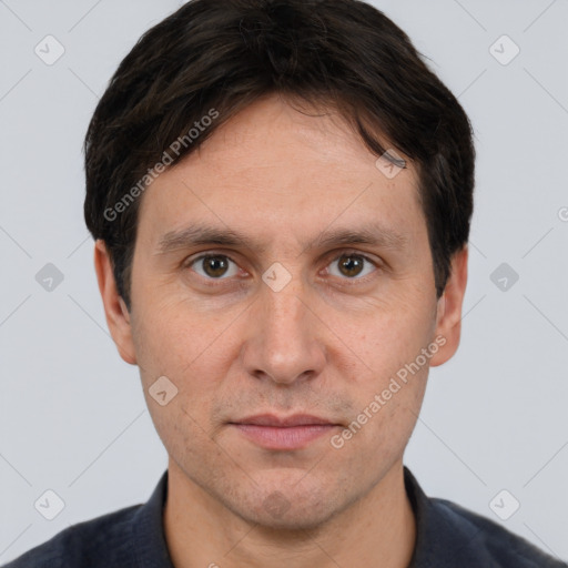 Joyful white adult male with short  brown hair and brown eyes