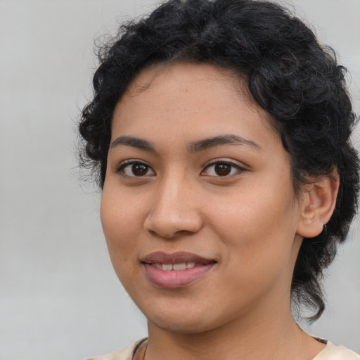 Joyful latino young-adult female with medium  black hair and brown eyes