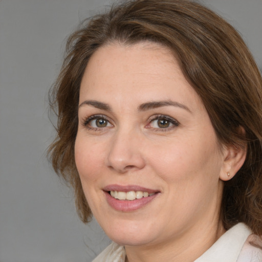 Joyful white adult female with medium  brown hair and brown eyes