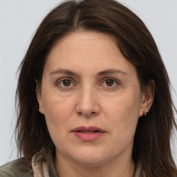 Joyful white adult female with long  brown hair and brown eyes