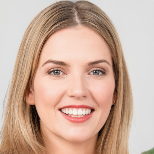 Joyful white young-adult female with long  brown hair and green eyes