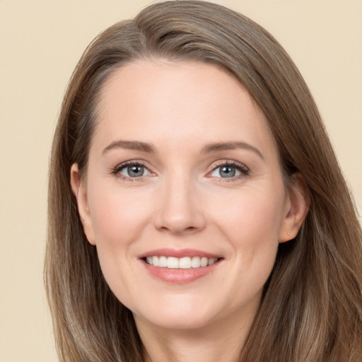 Joyful white young-adult female with long  brown hair and brown eyes