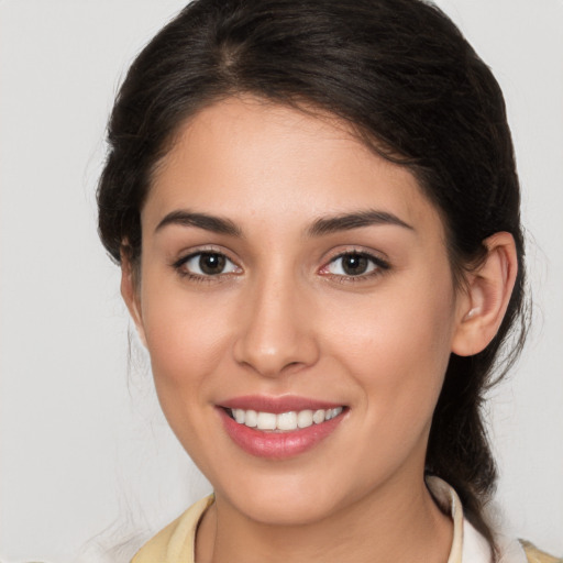 Joyful white young-adult female with medium  brown hair and brown eyes