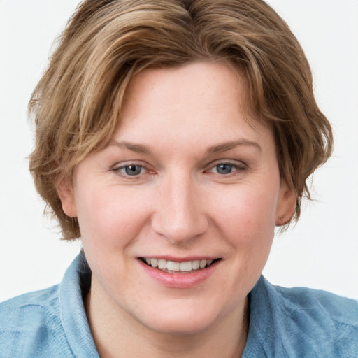 Joyful white young-adult female with medium  brown hair and blue eyes