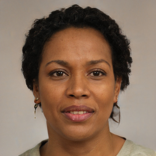 Joyful black adult female with short  brown hair and brown eyes