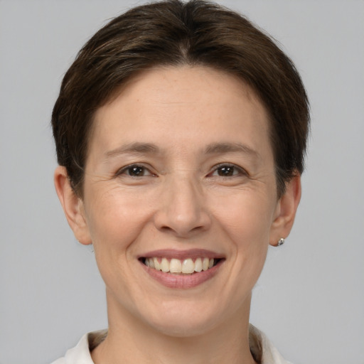 Joyful white adult female with short  brown hair and brown eyes