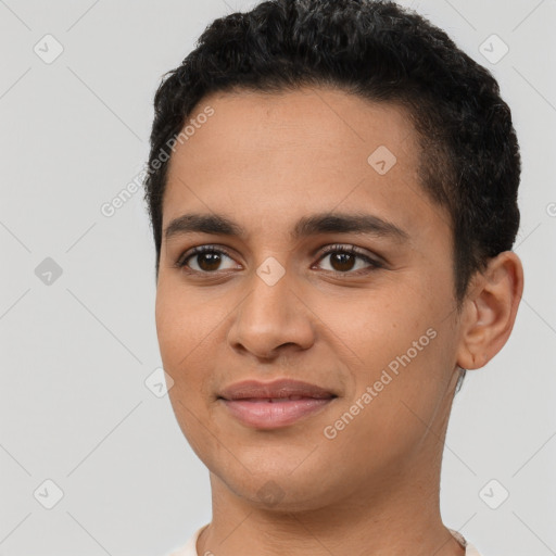 Joyful latino young-adult male with short  black hair and brown eyes