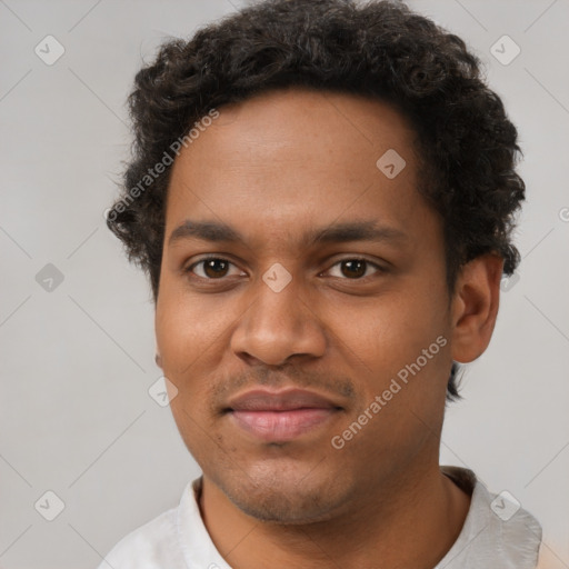 Joyful black young-adult male with short  brown hair and brown eyes