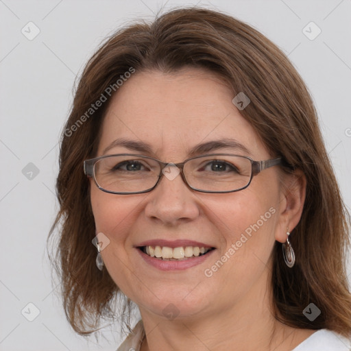 Joyful white adult female with medium  brown hair and blue eyes