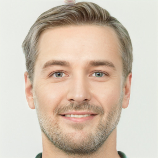 Joyful white young-adult male with short  brown hair and green eyes