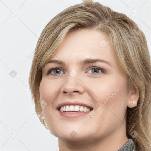 Joyful white young-adult female with medium  brown hair and blue eyes