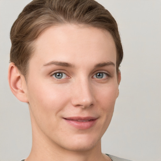 Joyful white young-adult female with short  brown hair and grey eyes