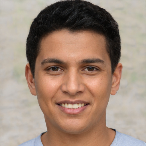 Joyful white young-adult male with short  black hair and brown eyes