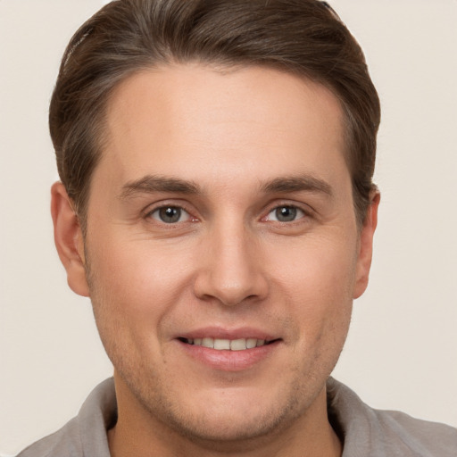 Joyful white young-adult male with short  brown hair and brown eyes