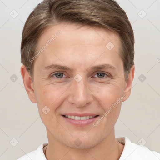 Joyful white adult male with short  brown hair and grey eyes