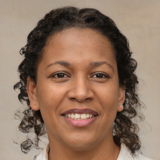 Joyful latino adult female with medium  brown hair and brown eyes