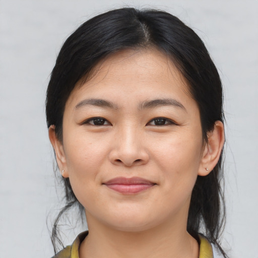 Joyful asian young-adult female with medium  brown hair and brown eyes