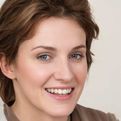 Joyful white young-adult female with medium  brown hair and blue eyes