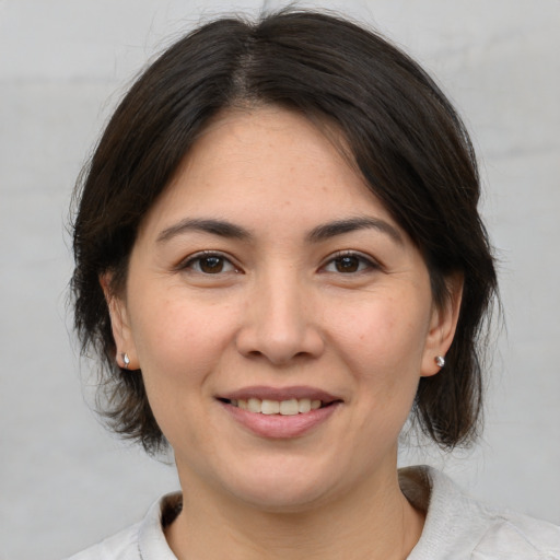 Joyful white adult female with medium  brown hair and brown eyes