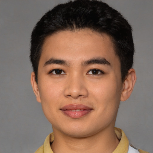 Joyful asian young-adult male with short  brown hair and brown eyes