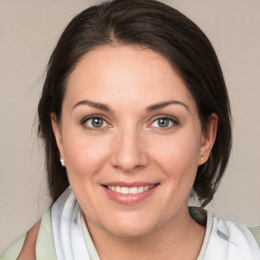 Joyful white young-adult female with medium  brown hair and brown eyes