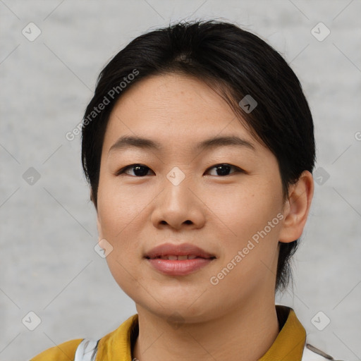 Joyful asian young-adult female with short  brown hair and brown eyes