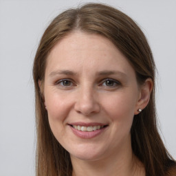 Joyful white young-adult female with long  brown hair and grey eyes