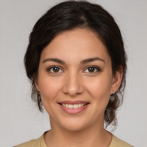 Joyful white young-adult female with medium  brown hair and brown eyes