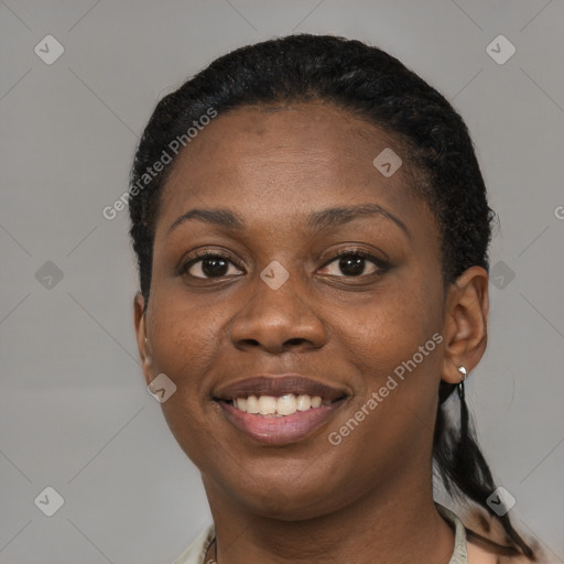 Joyful black young-adult female with short  black hair and brown eyes